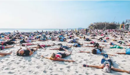  ?? Picture: CITY OF GOLD COAST ?? Gold Coast broke the world record for the most people doing ‘sand angels’ yesterday at Kurrawa Beach.