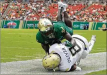  ?? MIKE EHRMANN / GETTY IMAGES ?? Tech quarterbac­k Tobias Oliver is tackled by South Florida’s Ronnie Hoggins during last season’s game at Raymond James Stadium. South Florida lost its opener 49-0 to Wisconsin at home last week.