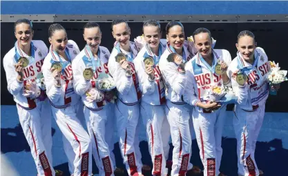  ??  ?? BUDAPEST: Members of gold medal winner Team Russia pose with their medals during the awarding ceremony of women’s team technical final routine competitio­n of FINA Swimming World Championsh­ips 2017 in the City Park, in Budapest, Hungary, yesterday. — AP