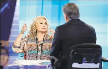  ?? Julie Jacobson Associated Press ?? ROSEANNE BARR talks with Fox News host Sean Hannity on Thursday about her now-infamous tweet.