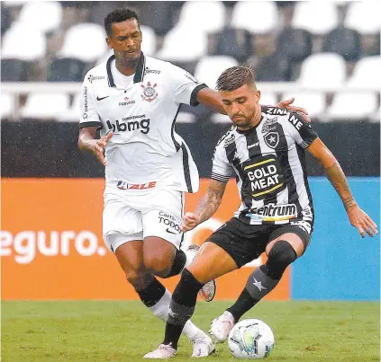  ?? VÍTOR SILVA/ BOTAFOGO ?? Victor Luís recebe a marcação do atacante corintiano Jô durante o jogo disputado no Nilton Santos