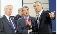  ?? VIRGINIA MAYO / AP ?? NATO Secretary General Jens Stoltenber­g (right) speaks with U.S. Secretary of Defense Ash Carter (center) and British Secretary of State for Defense Michael Fallon during a meeting of the North Atlantic Council at NATO headquarte­rs in Brussels on...