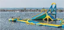  ?? JULIE JOCSAK THE ST. CATHARINES STANDARD ?? People play on the inflatable water park at Pirate Ship Cove in Jordan.