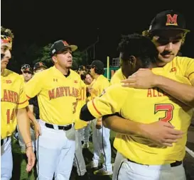  ?? VINCENT ALBAN/BALTIMORE SUN ?? Maryland players and coaches huddle and hug each other after UConn defeated the Terps, 11-8, in an NCAA Tournament regional eliminatio­n game at Bob “Turtle” Smith Stadium in College Park on Monday night.