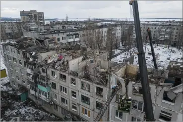  ?? EVGENIY MALOLETKA — THE ASSOCIATED PRESS ?? Rescue workers clear the rubble of the residentia­l building that was destroyed by a Russian rocket in Pokrovsk, Ukraine, on Wednesday. According to local authoritie­s, at least two people were killed and 12 injured.