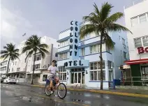  ??  ?? Miami Beach resident Martin Nesvig rides his bicycle down an empty Ocean Drive near the Colony Hotel in Miami Beach on April 1. Hotels that have been shuttered have been busy getting ready to reopen on June 1.