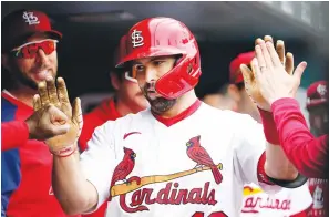  ?? Associated Press ?? ■ St. Louis Cardinals’ Paul Goldschmid­t is congratula­ted by teammates after hitting a solo home run during the first inning of a baseball game Monday against the Kansas City Royals in St. Louis.