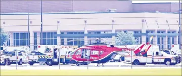  ?? — AFP photo ?? Emergency crews stage in the parking lot of Santa Fe High School, Texas.