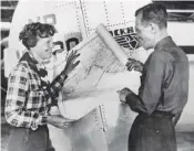  ?? AP FILE PHOTO ?? Aviator Amelia Earhart, left, and navigator Fred Noonan pose with a map of the Pacific Ocean showing the planned route of their round-the-world flight.