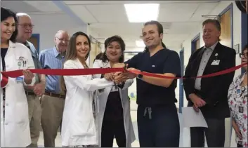  ?? PHOTO TOM BODUS ?? Dr. Ameen Alashareef (center, in black), chairman of pediatric services for Pioneers Memorial Healthcare District, prepares to cut the ribbon in celebratio­n of the pediatric unit’s grand reopening Tuesday.