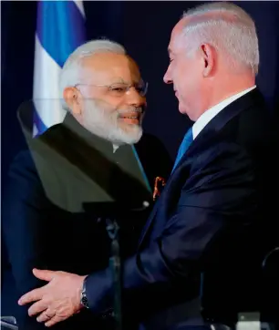  ??  ?? Prime Minister Narendra Modi shakes with his Israeli counterpar­t Benjamin Netanyahu in occupied Jerusalem on Wednesday. — AFP