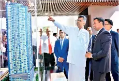  ??  ?? Blue Mountain Group Chairman Dr. Hiran Hettiarach­chi accompanie­s Megapolis and Western Developmen­t Minister Patali Champika Ranawaka while he examines the design PIX BY KITHSIRI DE MEL