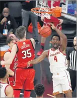  ?? ETHAN MILLER – GETTY IMAGES ?? USC’s Evan Mobley dunks against Utah’s Branden Carlson for two of his 26 points Thursday night.