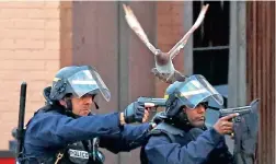  ?? PICTURE: AP ?? NO FALSE MOVES: Police officers in action in Saint-Denis, on the hunt for terror suspect and mastermind Abdelhamid Abaaoud, yesterday.