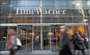  ?? ASSOCIATED PRESS ?? IN THIS 2007 file photo, people walk by the Time Warner Center in New York. Time Warner Inc. on Wednesday said it has rejected a takeover bid from 21st Century Fox and says it has no interest in further discussion­s with Rupert Murdoch’s media...