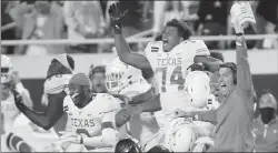  ?? BRIAN BAHR/GETTY ?? Texas’ Rafiti Ghirmai, 74, and the Longhorns celebrate their victory over OSU on Saturday.