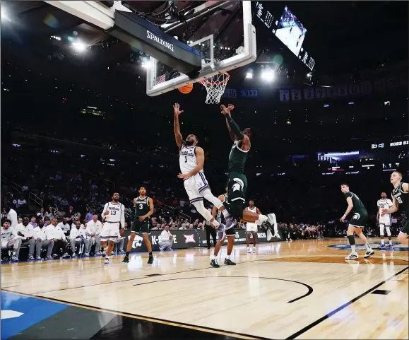  ?? (AP Photo/Frank Franklin II) ?? Kansas State guard Markquis Nowell makes a layup in the second half during the Wilkdcats’ victory over Michigan State in the East Regional semifinals of the NCAA Tournament on Thursday at Madison Square Garden in New York. Nowell, who transferre­d from the University of Arkansas-Little, grew up in New York, but this weekend was his first time playing at the Garden.