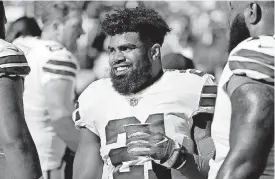  ?? [AP PHOTO] ?? Dallas Cowboys running back Ezekiel Elliott smiles on the sideline after scoring a touchdown during a game against the San Francisco 49ers in Santa Clara, Calif., on Oct. 22.