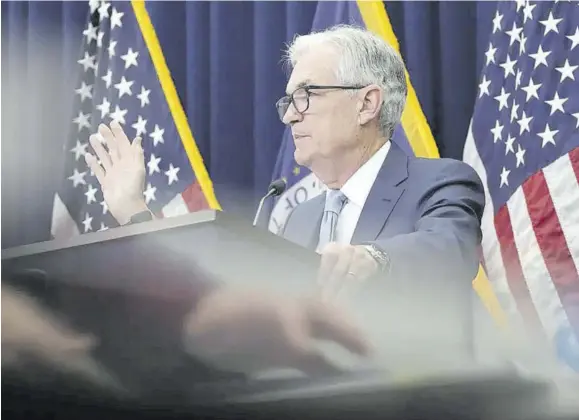  ?? ?? Federal Reserve Chair Jerome Powell speaks during a news conference Wednesday, December 14, 2022 at the Federal Reserve Board Building, in Washington, as an aides hand reflects under the podium. On Wednesday, the Federal Reserve closes its two-day meeting where economists expect the central bank to raise its benchmark rate by a quarter of a point as its battle against four-decade high inflation extends into 2023