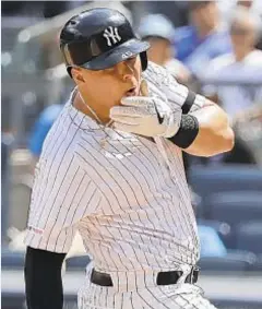  ?? AP ?? Luke Voit reacts after being hit in the face with a fastball.