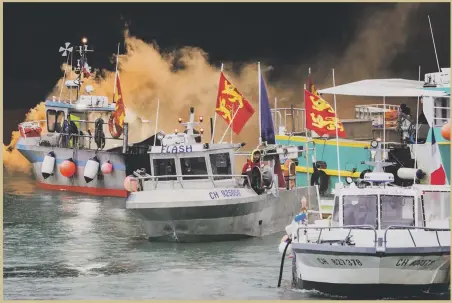  ?? AP ?? French fishermen gather near the Channel Island of Jersey on Thursday in protest against a loss of access to waters off their coast after Brexit. Officials said about 50 boats from French ports joined the demonstrat­ion.