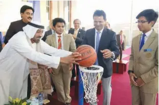 ?? Prashanth Mukundan / The Gulf Today ?? Sheikh Ahmed shoots the basket as he declares open the new basketball court at the school along with other facilities.
