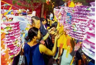  ??  ?? Vivid colours: Visitors looking at lanterns along Carpenter Street for the annual Kuching Inter- Cultural Mooncake Festiva.