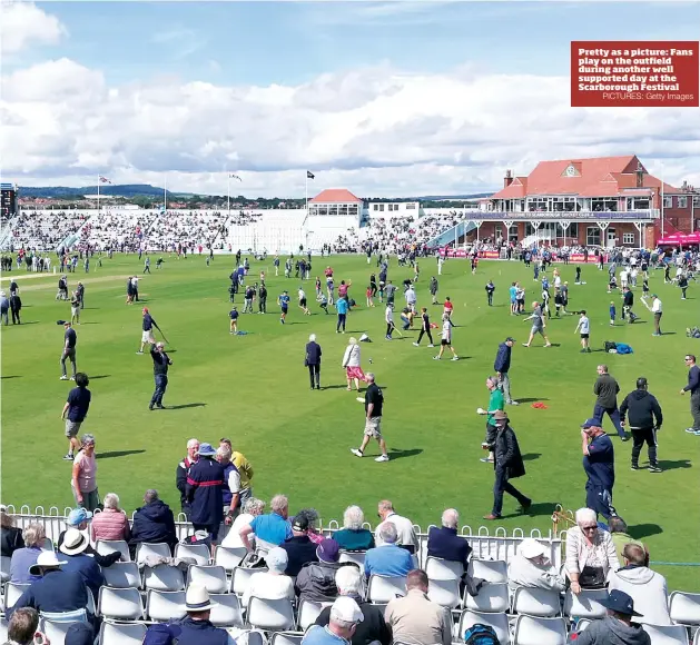  ?? PICTURES: Getty Images ?? Pretty as a picture: Fans play on the outfield during another well supported day at the Scarboroug­h Festival