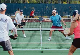  ?? Kirk Sides/Staff photograph­er ?? Pickleball players — or just about any sports enthusiast­s — who overdo it on the court may get relief from muscle cramps by drinking pickle juice.