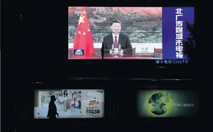  ?? Photo: Nampa/AFP ?? New norm… An image of Chinese President Xi Jinping appearing by video link at the United Nations 75th anniversar­y is seen on an outdoor screen as a pedestrian walks past below in Beijing.