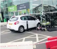  ??  ?? THIS is the dramatic aftermath of the moment a driver lost control of his car and crashed into a supermarke­t window.
The 89-year-old man rammed into the Asda store in Ashington, Northumber­land, at 1.47pm on Tuesday.
The man’s granddaugh­ter posted...