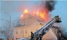  ?? DAVE JOHNSON TORSTAR ?? Flames break through the roof of 683 King St. at the corner of Ontario Road during a fire Wednesday morning in Welland.