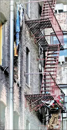  ??  ?? Windows of burned apartments are seen after a fire in a building in Bronx, New York. — Reuters photo