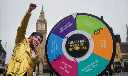  ?? ?? A Rishi Sunak look-a-like spins a Rwanda bill 'Wheel of Misfortune' outside parliament earlier this month. Flights to Rwanda may well not now take off this spring as the prime minister hoped. Photograph: Vuk Valcic/Zuma Press Wire/Rex/Shuttersto­ck