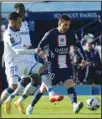  ?? ?? PSG’s Lionel Messi (right), challenges for the ball with Auxerre’s Hamza Sakhi (left), during the French League One soccer match between Paris Saint Germain and Auxerre at Parc des Princes stadium in Paris. (AP)