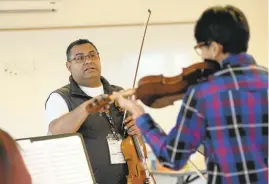  ??  ?? Above: Teacher Abigail Torres works with students in a violin workshop at the festival.