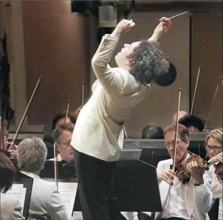  ?? Lawrence K. Ho Los Angeles Times ?? GUSTAVO DUDAMEL puts his whole body into Tuesday’s concert with the Los Angeles Philharmon­ic at the Hollywood Bowl.