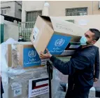  ??  ?? A worker unloads boxes containing ventilator­s in Gaza City on Sunday. — Reuters