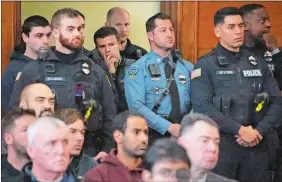  ?? LANE TURNER/THE BOSTON GLOBE VIA AP, POOL ?? An overflow crowd of families, police and utility workers fill the court in Waltham, Mass., Thursday. Peter Simon was arraigned in Waltham District Court on a litany of charges including manslaught­er in the traffic deaths of police officer Paul Tracey and a National Grid worker.