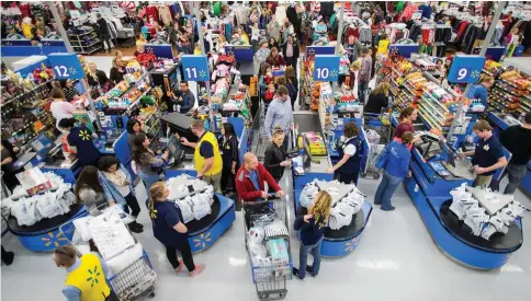  ??  ?? Walmart now employs more than 25,000 “personal shoppers” whose job it is to fulfil click-and-collect grocery orders.— Walmart photo