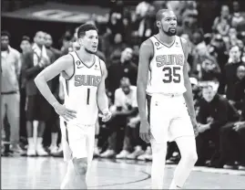  ?? ?? Devin Booker, left and Kevin Durant combined for 73 points to lead the Phoenix Suns to a 129-124 victory in Game three of their Western Conference first round matchup. (Photo courtesy Phoenix Suns website)