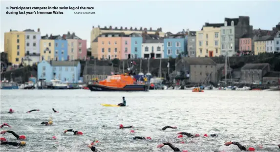  ?? Charlie Crowhurst ?? &gt; Participan­ts compete in the swim leg of the race during last year’s Ironman Wales