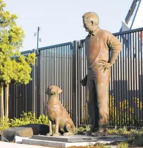  ?? K.C. ALFRED U-T ?? The statue of former San Diego Union editor/columnist Jack Murphy and his dog Abe is located outside north entrance of San Diego State’s Snapdragon Stadium in Mission Valley.