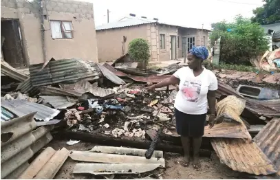  ?? Picture: Musa Binda ?? CHARRED REMAINS. Bongiwe Mazeka points out the remains of her burnout home. Her three children were rescued by a neighbour. Two of the children are being treated for burn wounds.