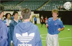  ?? Associated Press file photo ?? Zico, technical director of Japan’s pro-football league’s Kashima Antlers, right, gives a heading lecture to Japanese soccer fans during his training session in Tokyo in 1996.