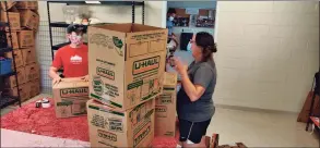  ??  ?? Above right, workers at Norwalk Mutual Aid help distribute supplies. Above left, Norwalk Mutual Aid workers load items onto a truck.