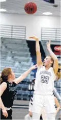  ?? [PHOTO BY SARAH PHIPPS, THE OKLAHOMAN] ?? Edmond North’s Kamri Heath shoots as Norman North’s Kennedy Cummings defends during Friday’s girls basketball game at Edmond North High School in Edmond.