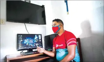  ?? AFP ?? Zacary Egea speaks in front of the computer he normally uses to play the Plant Vs Undead video game in the Cuaricuao neighbourh­ood of the Libertador municipali­ty of Caracas.