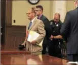  ?? NICHOLAS BUONANNO -- NBUONANNO@ TROYRECORD.COM ?? A Rensselaer County Courtroom Officer places handcuffs on Christophe­r Neumann after he was sentenced to two to six years in prison Monday morning. Neumann’s attorney James Long stands next to his client.