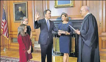  ?? AP ?? Retired Justice Anthony M Kennedy (right) administer­s the Judicial Oath to Judge Brett Kavanaugh, who is accompanie­d by his family, in the Justices' Conference Room of the US Supreme Court.